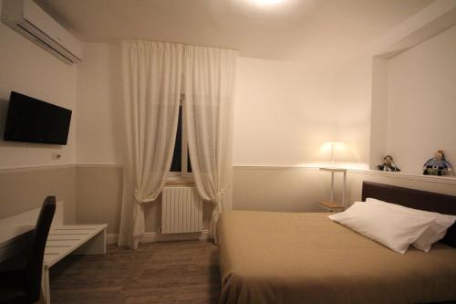 a hotel room with a bed and a window at Principe in Bari
