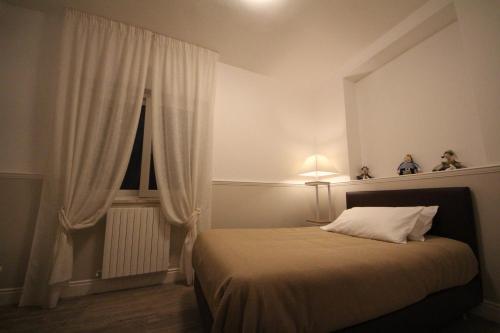 a bedroom with a bed and a window at Principe in Bari