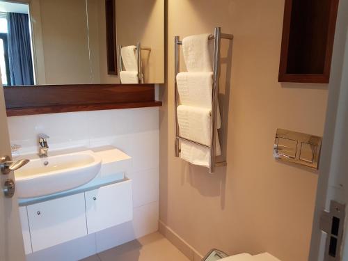 a bathroom with a sink and a mirror at Zimbali Suites 307 in Ballito