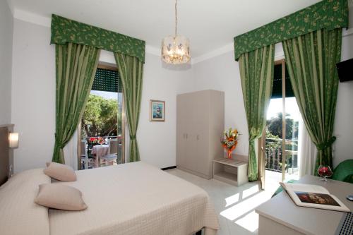 a bedroom with a bed and a large window at Hotel Giulio Cesare in Rapallo