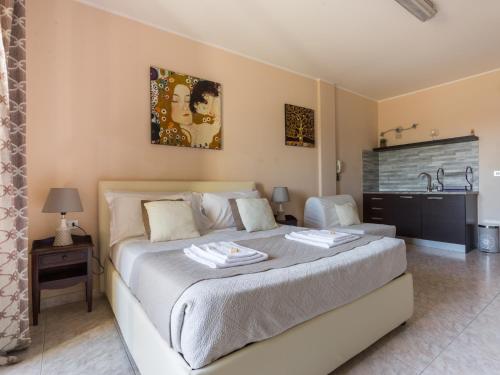 a bedroom with a large bed and a sink at Residenze Su Planu in Cagliari