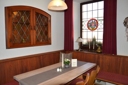 a dining room with a table and a stained glass window at Hotel Gasthof Metzgerei Lamm - Benedikt Rückel in Geiselwind