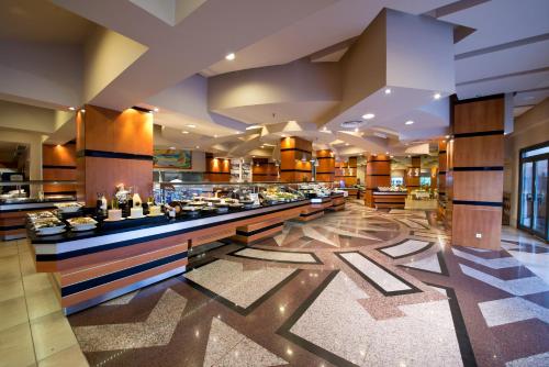 a restaurant with a buffet line in a hotel at Limak Limra Hotel & Resort Kemer - Kids Concept in Kemer