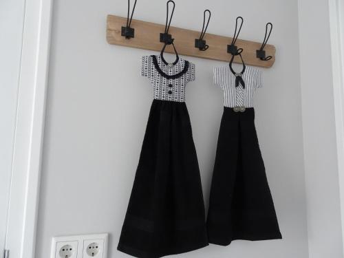 a pair of black skirts hanging on a wall at An en Bie in Aagtekerke