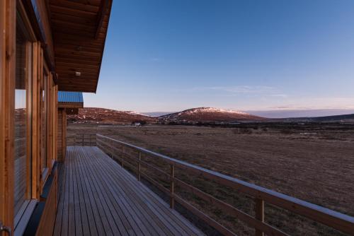 a porch of a house with a view of a field at Guesthouse Brekka in Brekka
