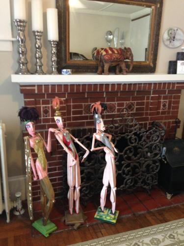 two wooden mannequins standing in front of a fireplace at The John Randall House in Provincetown
