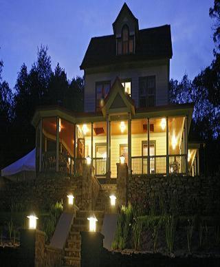 a large house with lights on it at night at Breezy Hill Inn in Fleischmanns
