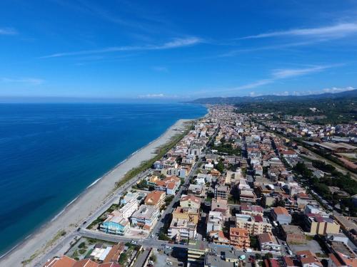 an aerial view of a city next to the ocean at La Baia Di Ulisse in Venetico