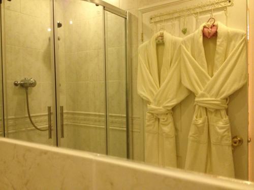 a robe hanging in front of a bathroom mirror at Snowdonia Snug - Studio Style Accommodation in Dolgellau