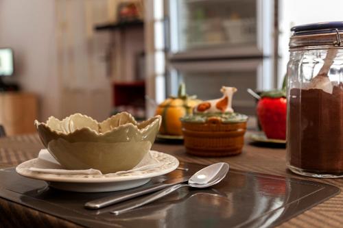 a table with a bowl of food and a spoon at Peniche Hostel in Peniche