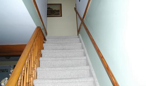 a staircase in a house with white walls at Estuary House Reflexology B&B in Courtenay