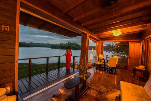 a room with a balcony with a view of the water at Las Lagunas Boutique Hotel in Flores