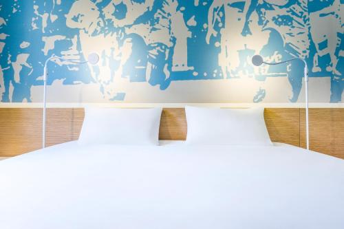 Ένα ή περισσότερα κρεβάτια σε δωμάτιο στο ibis Styles Toulouse Nord Sesquieres