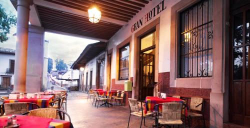 un restaurante al aire libre con mesas y sillas con manteles rojos en Gran Hotel Pátzcuaro, en Pátzcuaro