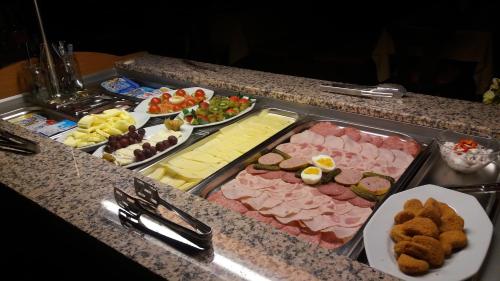 a buffet with different types of food on a counter at Hotel Sonnenhof in Cham