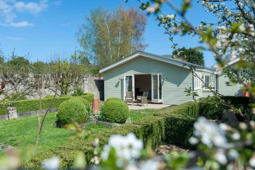 a small white house with a yard at Hubbard's Luxury Bed and Breakfast in South Creake