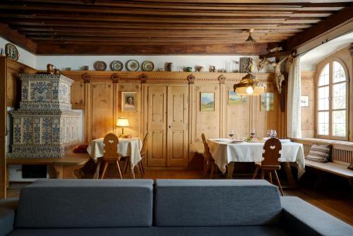a living room with two tables and a couch at Parkhotel Post in Chiusa