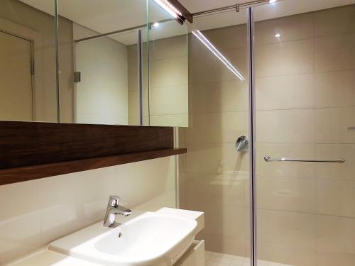 a bathroom with a sink and a shower at Zimbali Suites 106 in Ballito
