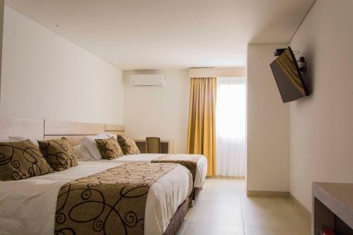Ένα ή περισσότερα κρεβάτια σε δωμάτιο στο Hotel Arawak Plaza