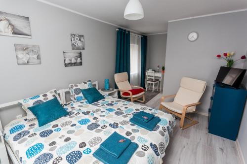 a bedroom with a bed with blue pillows on it at Grey House in Wrocław
