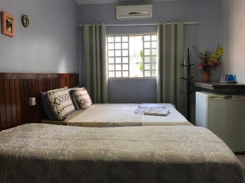 Posteľ alebo postele v izbe v ubytovaní Pousada Castelinho