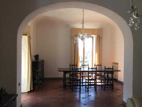 a dining room with a table and chairs and a window at Villa Il Padule in Bagno a Ripoli
