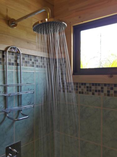 a shower in a bathroom with a shower curtain at Ocean Melody 2 in Uvita