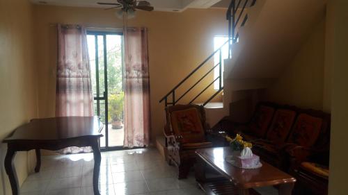 a living room with a couch and a piano at D downhill'Place in Oslob
