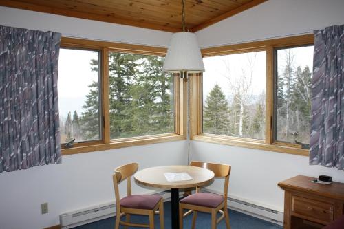 a wooden table in a room with a window at Superior Ridge Resort Motel in Schroeder