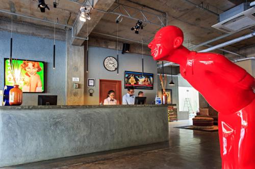 a large red statue of a person standing at a bar at The Henry Hotel Cebu in Cebu City