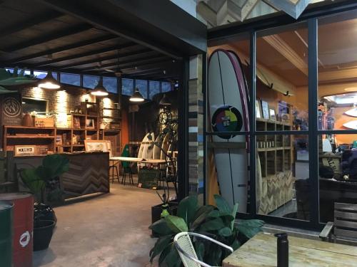 a store front with a surfboard in the window at Donghe surf shop & Hostel in Donghe