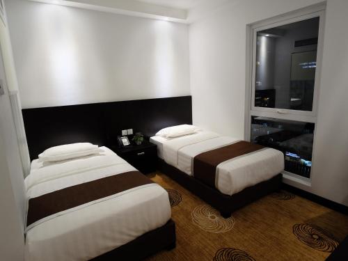 Ένα ή περισσότερα κρεβάτια σε δωμάτιο στο InnB Park Hotel