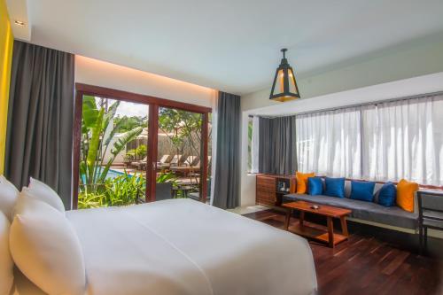 a bedroom with a bed and a couch at Apsara Residence Hotel in Siem Reap