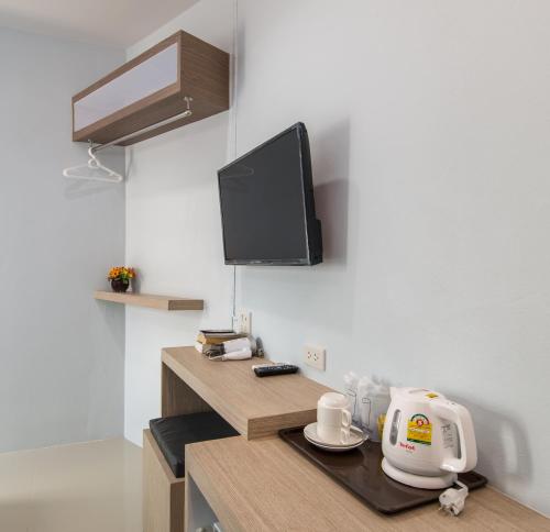 a kitchen with a counter with a mixer and a tv at Lada Krabi Express in Krabi town