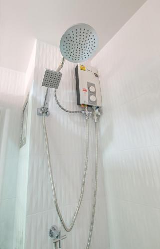 a shower with a shower head in a bathroom at Lada Krabi Express in Krabi town