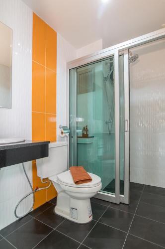 a bathroom with a toilet and a glass shower at Lada Krabi Express in Krabi town