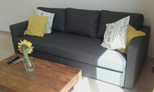a gray couch with pillows and a coffee table at El Globo in Valencia