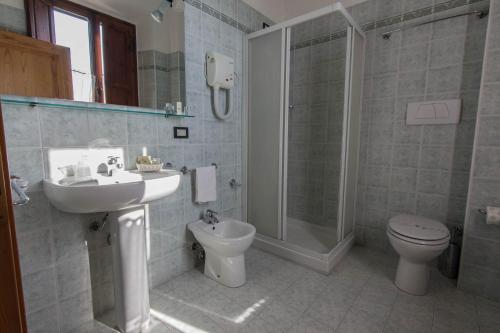 a bathroom with a sink and a toilet and a shower at Hotel Villa Porta All'Arco in Volterra