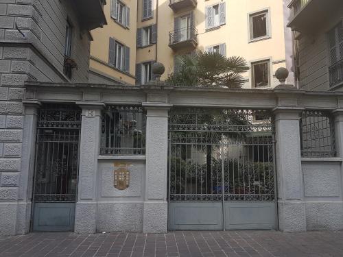 a building with a gate in front of a building at Aldebaran in Milan