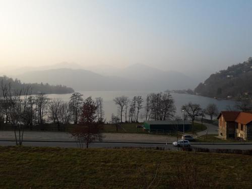 a car driving down a road next to a lake at Hotel Bocciolo in Orta San Giulio