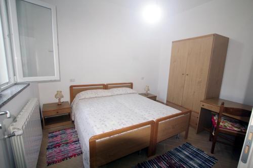 a bedroom with a bed and a dresser and a window at Appartamenti Torre in Capo Vaticano