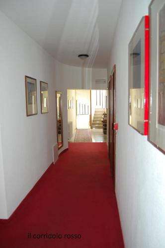 a red carpeted hallway with a red carpet and a red floor at La Rotonda in Pergine Valsugana