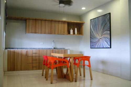 a kitchen with a table and four chairs at Z Pad Residences in Tacloban