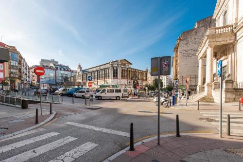 an empty street in a city with cars and buildings at Urban Suite Santander in Santander