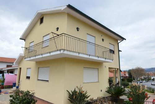 a yellow building with a balcony on it at Casa das Andorinhas in Ponte de Lima
