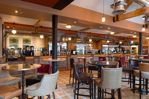 a restaurant with tables and chairs and a bar at The Bull & Stirrup Hotel Wetherspoon in Chester
