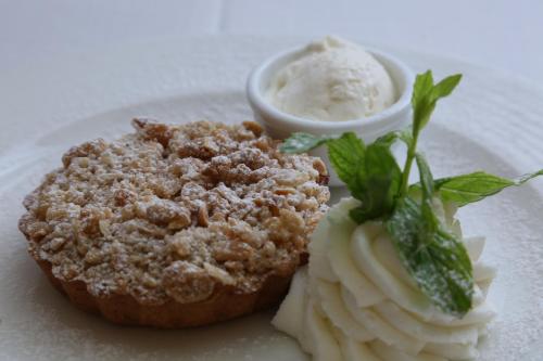 a plate of food with a muffin and ice cream at Ambassador Hotel in Jerusalem
