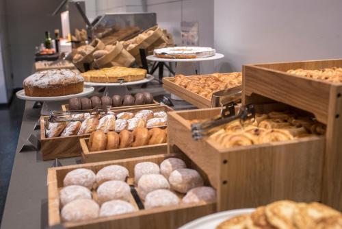 a bakery with many different types of donuts and pastries at Gran Hotel Havana 4Sup by Escampa Hotels in Barcelona