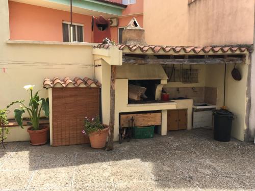 a kitchen with a counter and aesteadangering at Anna Apartment in Villaputzu