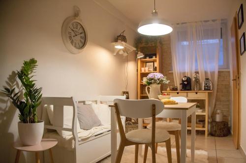 a kitchen and dining room with a table and chairs at The Nook Apartment in Zagreb